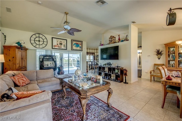 living room with ceiling fan, light tile patterned flooring, and lofted ceiling