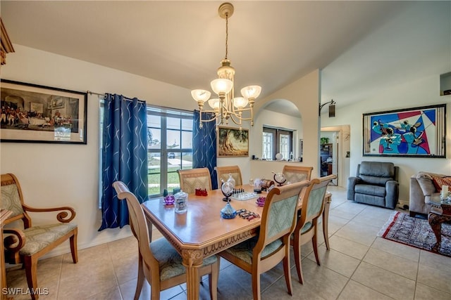 tiled dining area featuring an inviting chandelier