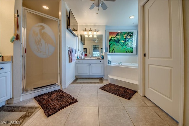 bathroom with tile patterned flooring, vanity, ceiling fan, and plus walk in shower