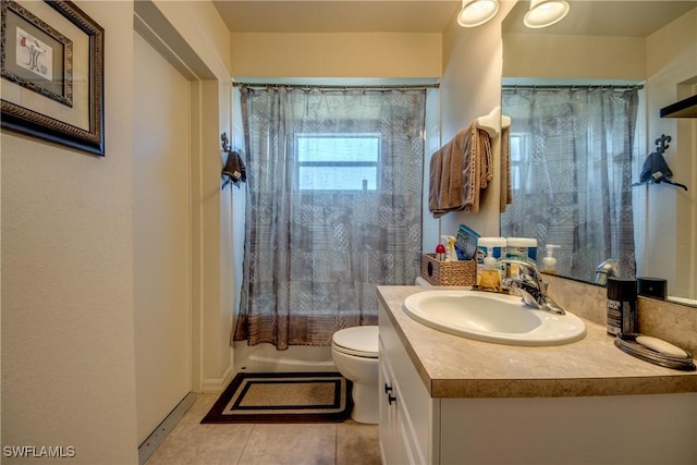 full bathroom featuring tile patterned floors, shower / bath combo with shower curtain, vanity, and toilet