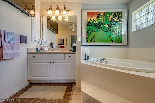 bathroom with tile patterned flooring, vanity, and a relaxing tiled tub