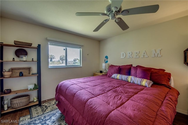 bedroom featuring ceiling fan and dark wood-type flooring