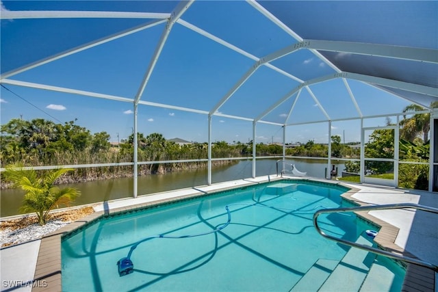 view of swimming pool featuring glass enclosure and a water view