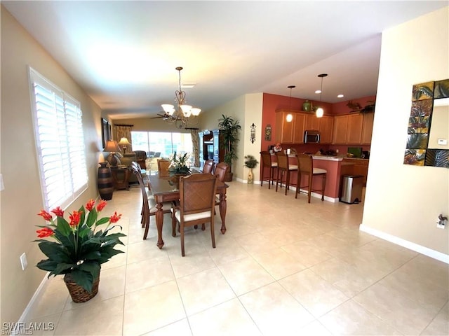 tiled dining space with a notable chandelier