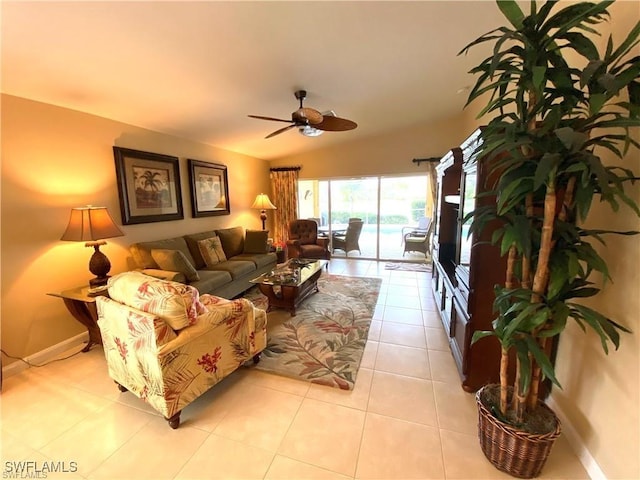 living room with ceiling fan, light tile patterned floors, and lofted ceiling