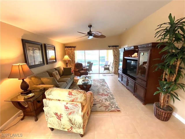 living room with ceiling fan and light tile patterned floors