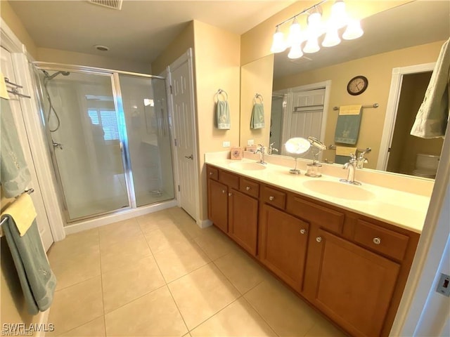 bathroom featuring an enclosed shower, vanity, tile patterned floors, and toilet