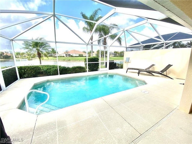 view of swimming pool with glass enclosure, a water view, and a patio