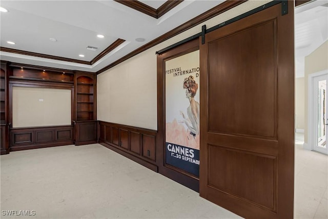 home theater room featuring a barn door and crown molding