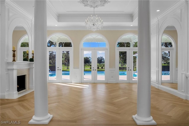 interior space featuring french doors, light parquet floors, a notable chandelier, and ornamental molding