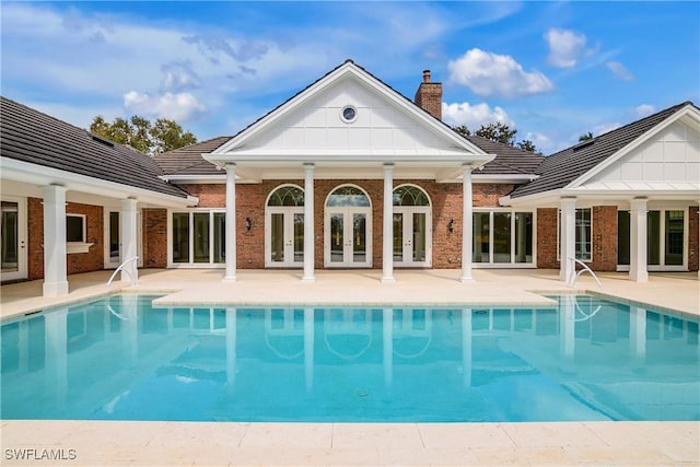 view of swimming pool featuring french doors and a patio area