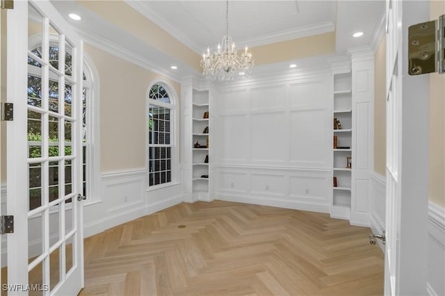 interior space featuring a notable chandelier, ornamental molding, and light parquet flooring