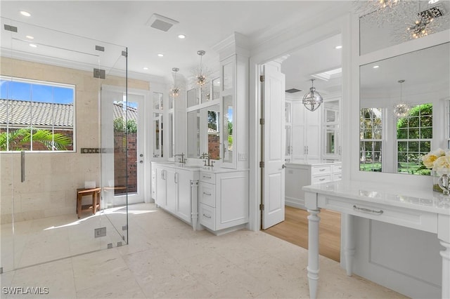 bathroom with plenty of natural light, an enclosed shower, and an inviting chandelier