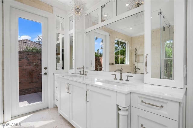 bathroom with vanity, walk in shower, and an inviting chandelier