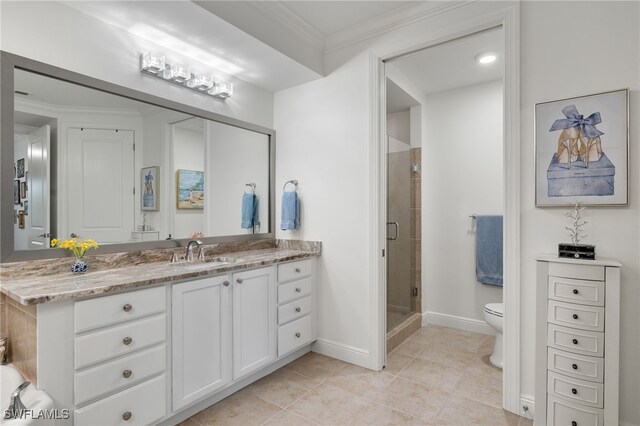 bathroom featuring vanity, tile patterned flooring, toilet, ornamental molding, and walk in shower