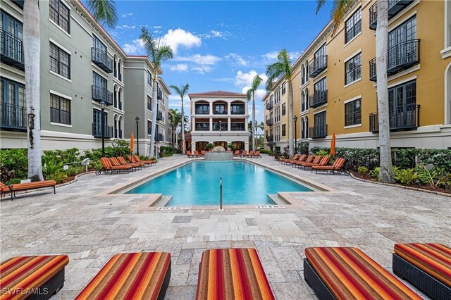 pool featuring a patio and a residential view