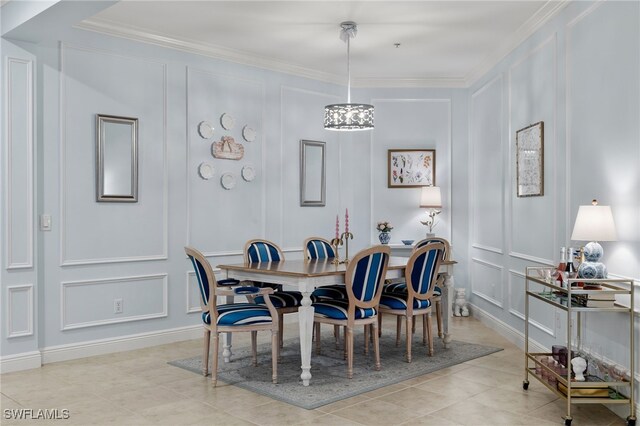 tiled dining area featuring ornamental molding