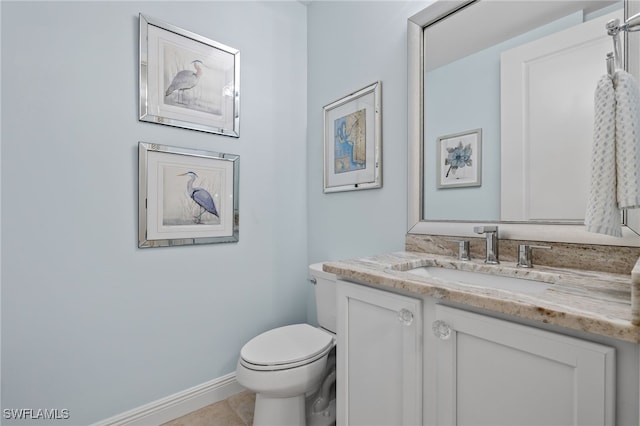 bathroom with tile patterned flooring, vanity, and toilet