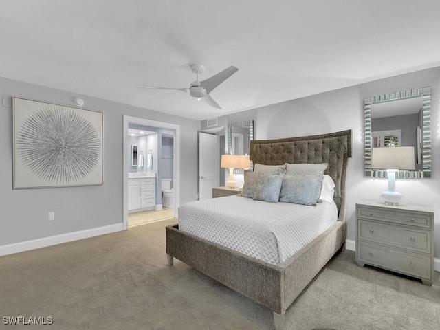 carpeted bedroom featuring ensuite bath and ceiling fan