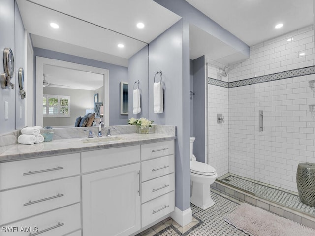 bathroom featuring toilet, walk in shower, tile patterned floors, ceiling fan, and vanity