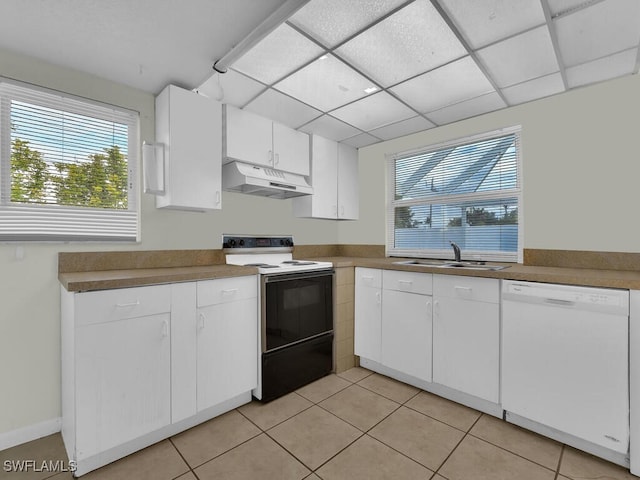 kitchen featuring white cabinets, sink, a drop ceiling, white dishwasher, and electric range