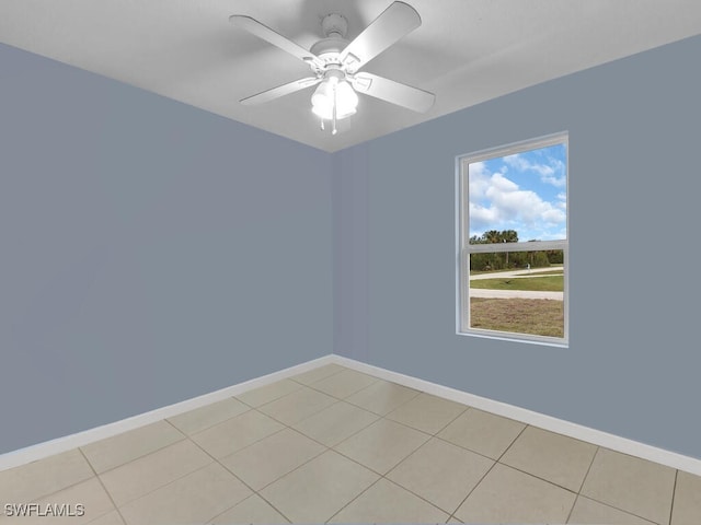 empty room featuring ceiling fan and light tile patterned floors