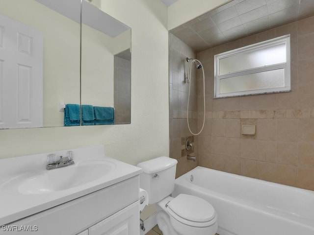 full bathroom with toilet, tiled shower / bath, and vanity