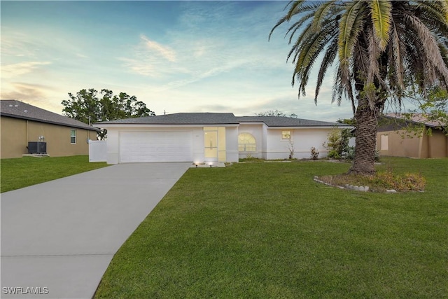 ranch-style house with a garage, central AC unit, and a lawn