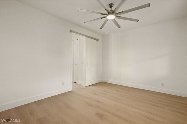 empty room with light wood-type flooring and ceiling fan