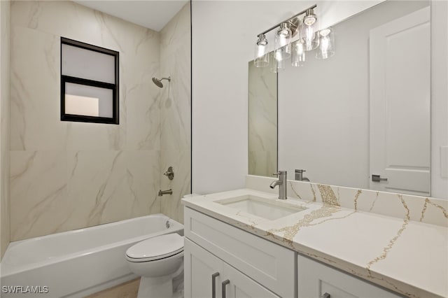 full bathroom featuring toilet, vanity, and tiled shower / bath