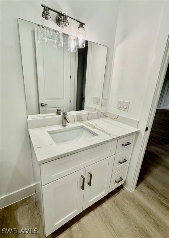 bathroom with vanity and wood-type flooring