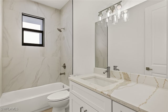 full bathroom with toilet, vanity, and tiled shower / bath