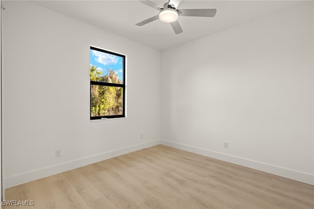 empty room with ceiling fan and light hardwood / wood-style flooring