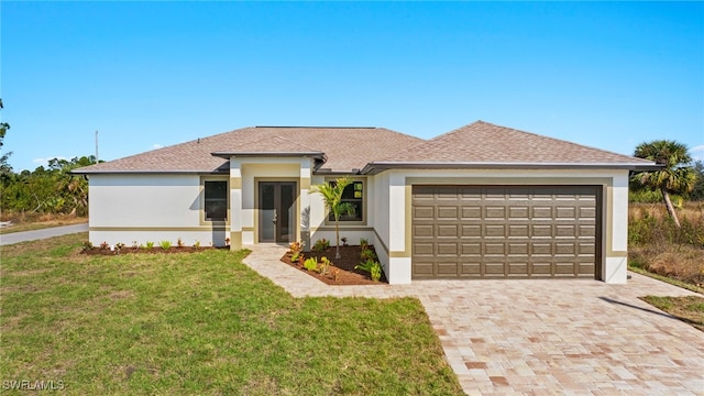 view of front of property featuring a garage and a front lawn