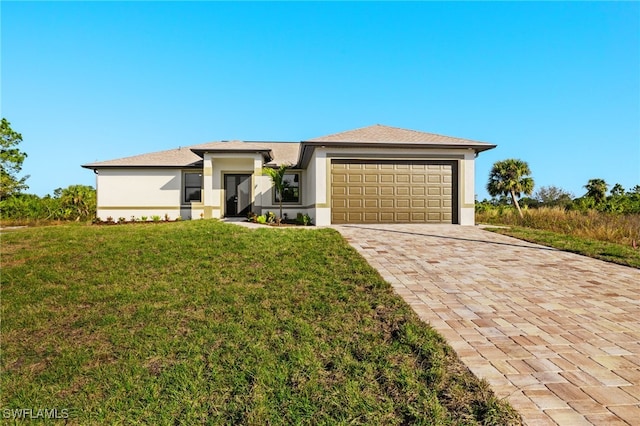 view of front of property with a front lawn and a garage