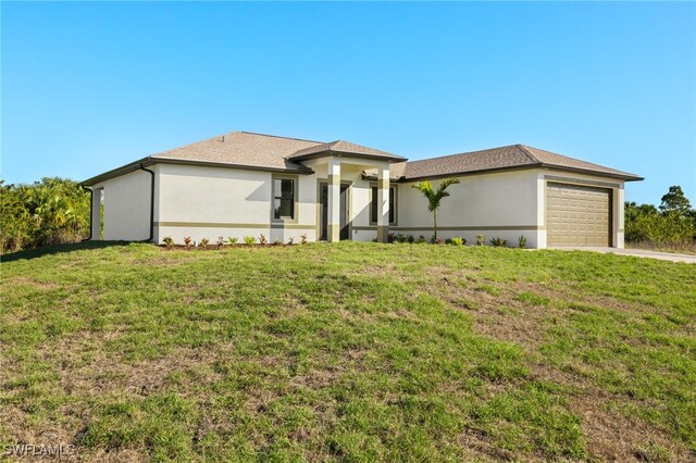 view of front facade with a front lawn and a garage