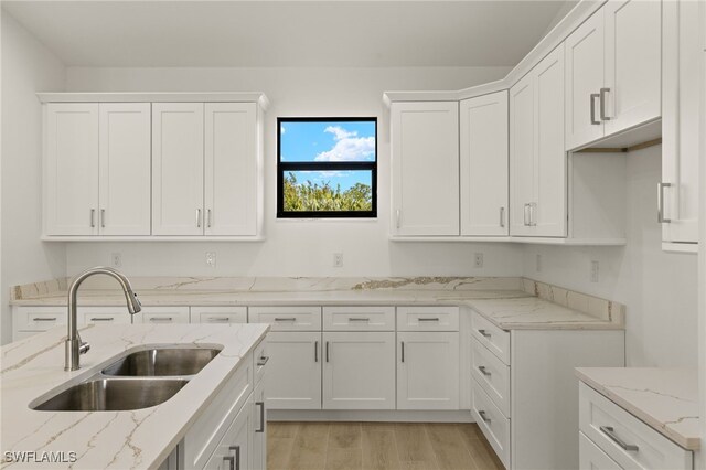 kitchen featuring sink and white cabinetry