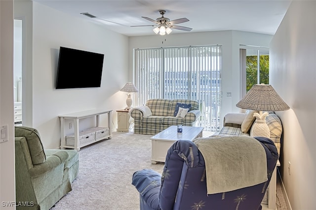 carpeted living room featuring ceiling fan