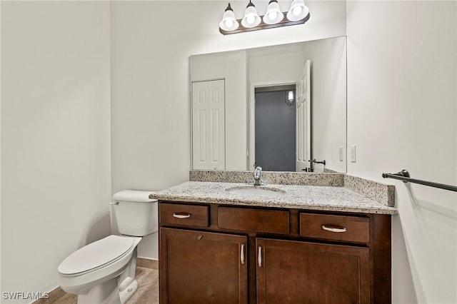 bathroom with tile patterned flooring, vanity, and toilet