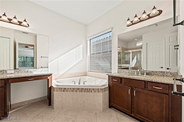 bathroom featuring plus walk in shower, vanity, tile patterned floors, and a healthy amount of sunlight