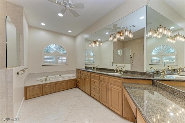 bathroom with ceiling fan, tile patterned flooring, vanity, and shower with separate bathtub