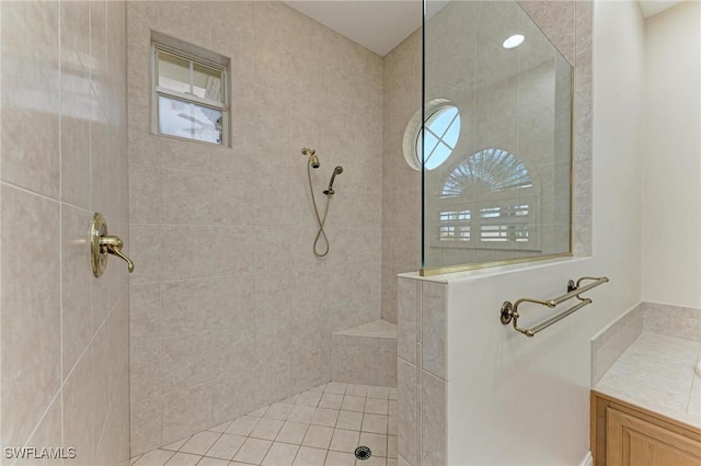 bathroom with vanity and a tile shower