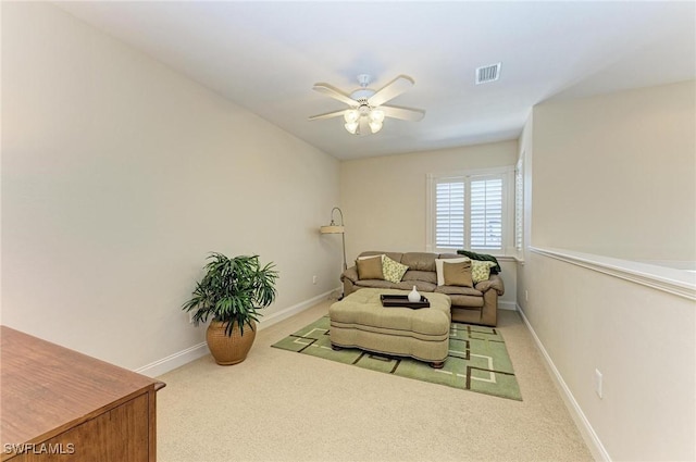 carpeted living room with ceiling fan