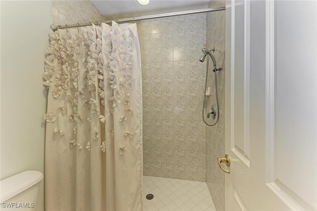 bathroom with a shower with curtain and toilet