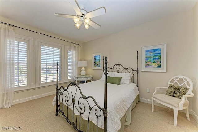 bedroom featuring light carpet and ceiling fan