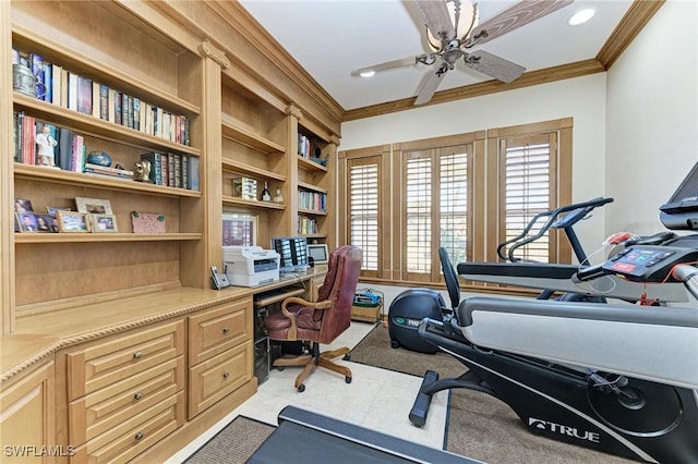 office area featuring built in desk, built in features, ceiling fan, and ornamental molding