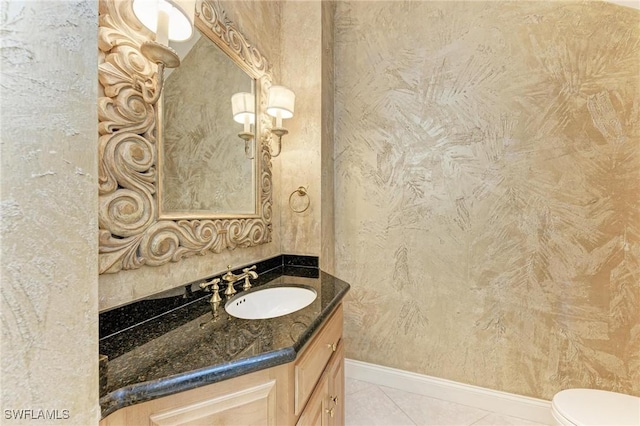 bathroom with tile patterned flooring, vanity, and toilet