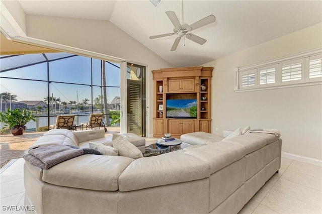 living room with light tile patterned floors, vaulted ceiling, and ceiling fan