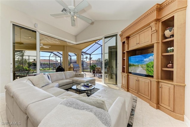 living room featuring ceiling fan, light tile patterned floors, and vaulted ceiling