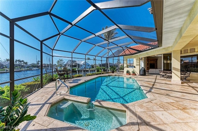 view of pool featuring glass enclosure, an in ground hot tub, a water view, and a patio